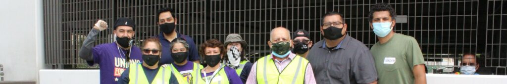 Group photo of workers wearing masks and reflective vests
