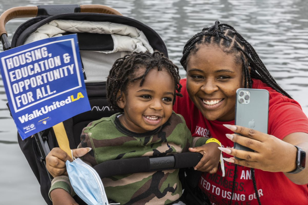 WalkUnited attendee taking a selfie with her young child