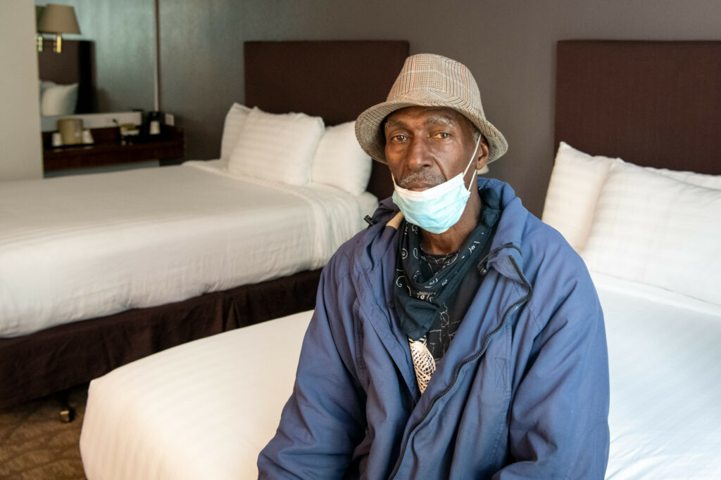 older gentlemen sitting on hotel bed