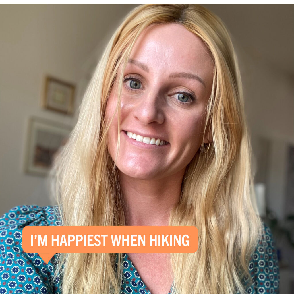 Portrait of Adria Shuford with a colorful tag displaying their fun fact "Happiest when hiking"