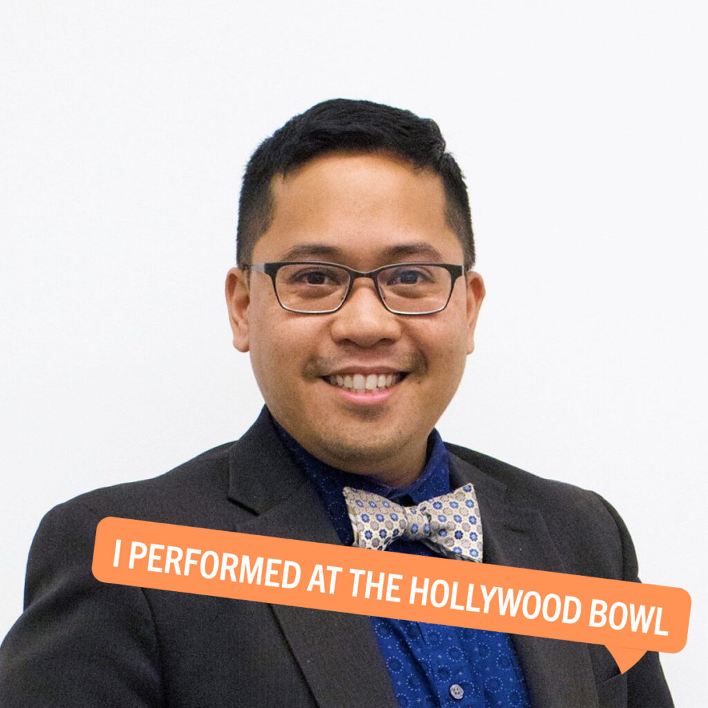 Portrait of AndyMike Emata with a colorful tag displaying their fun fact "I performed at the Hollywood Bowl"