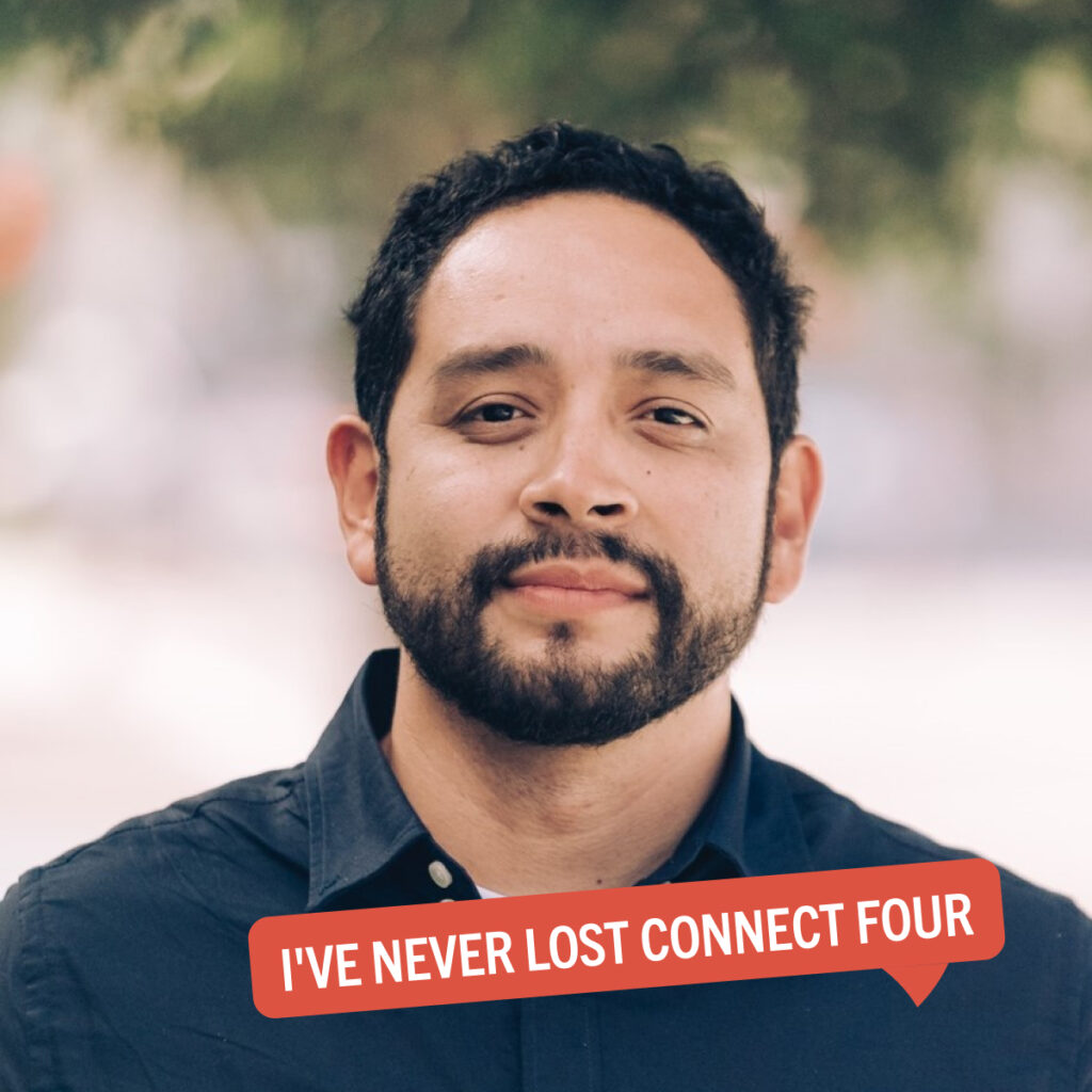 Portrait of Eric Ares with a colorful tag displaying their fun fact "I've never lost Connect Four"