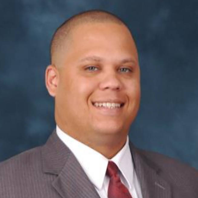 Headshot photo of Hassan Webb smiling