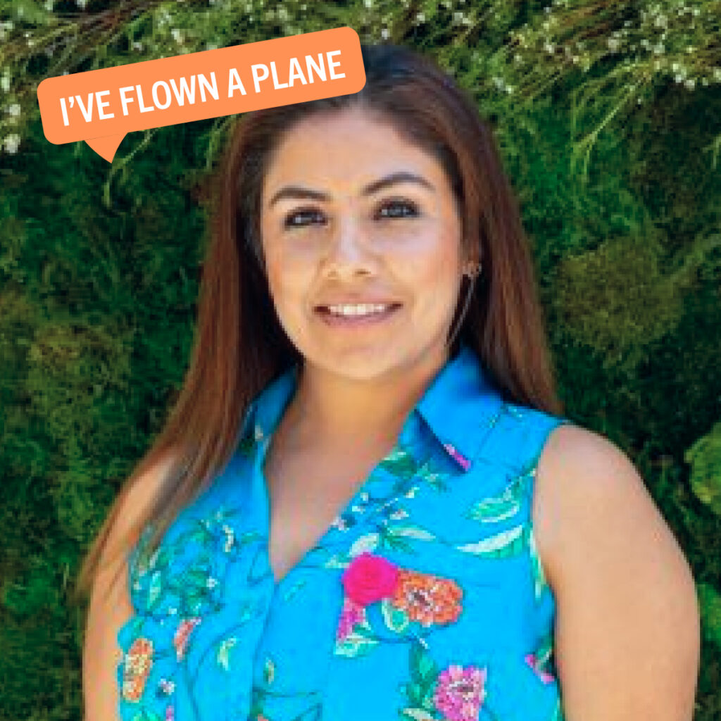 Mayra smiling at the camera beside a speech bubble that says "I've flown a plane"